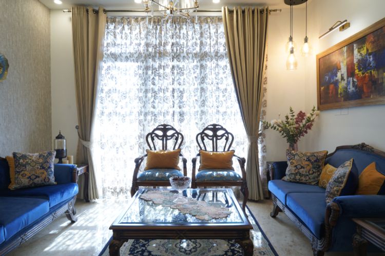 Compact Living Room Design With 3-Seater Wooden Sofas | Livspace