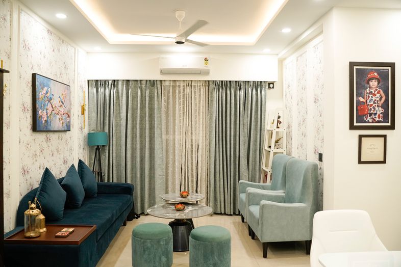 Living Room Design with Teal Sofa and Chairs, Floral Wallpaper, and White False Ceiling with Cove Lighting