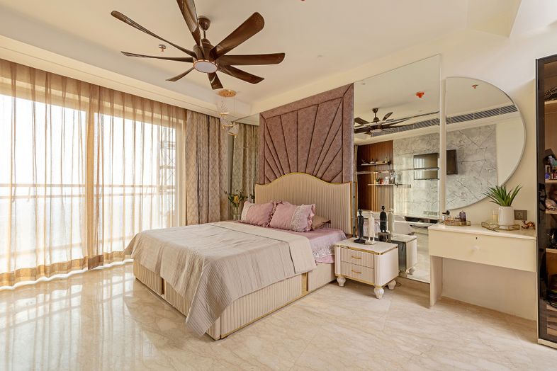 Bedroom Design with Tufted Headboard Wall and Crescent Mirror on Wall