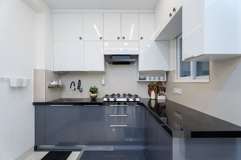 L-Shaped Kitchen Design with White and Grey Cabinets and Black Countertop