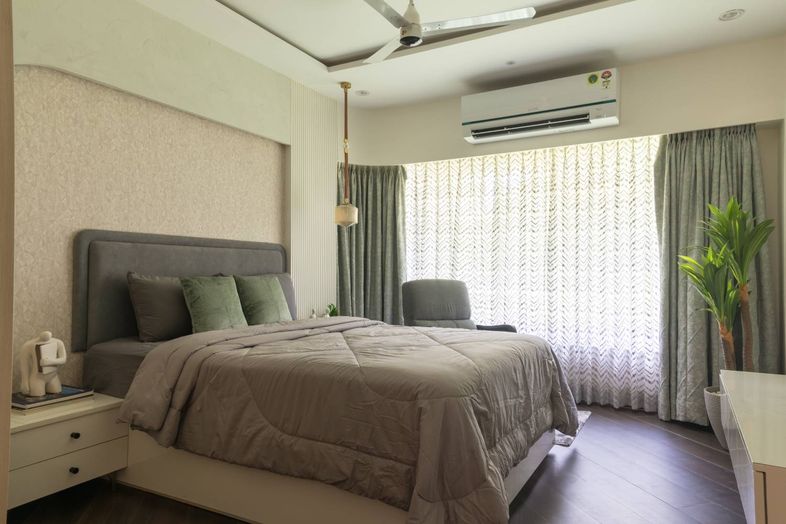 Bedroom Design with Beige Textured Wall, Grey Accent Chair and Grey Tufted Headboard Bed