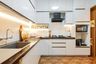 Cream L-Shaped Kitchen Design with Quartz Countertops
