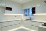 U Shaped Kitchen Design with White Glossy Cabinets and Quartz Countertop