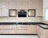 Cream L-Shaped Kitchen Design With Granite Countertop And Tall Storage