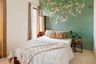 Guest Bedroom Design with Teal Botanical Mural and Wooden Bed
