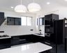 Black Island Kitchen Design With Glossy Cabinets and Quartz Top