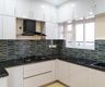 White U-Shaped Kitchen Design With Hexagonal Backsplash