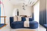 Living Room Design With Dark Blue Curved Sofa, Ombre Curtains and Wooden Detaling