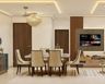 Dining room with cream chairs and integrated TV wall unit