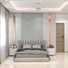 Guest bedroom with vertical panel accent wall, neutral bed, marble flooring, and curtains