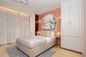 Kids Bedroom Design with Coral Pink Accent Wall and White Wardrobes