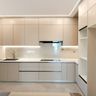L-Shaped Kitchen Design with Marble Countertop and Full-Height Cabinets