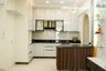 White Island Kitchen Design With Glossy Cabinets and Black Countertops