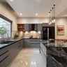 Kitchen with marble island, grey cabinets, and pendant lights for a modern touch