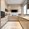 U-shaped kitchen with glossy beige cabinets, stone countertops, and natural lighting