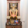 Pooja Room Design with Glass-Framed Idol and Drawers