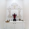 White Pooja Room Design with High Gloss Laminate Storage
