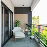 Contemporary balcony with grey accent wall and white accent chair - Livspace