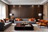 Modern living room design for large families with grey sofa & orange chairs - Livspace