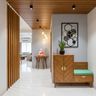 Contemporary Foyer Design with Slatted Wood Ceiling and Globe Pendant Cluster