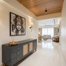 Classic Foyer Design with Wooden Plank Ceiling and Indian Deity Artwork