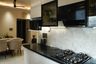 L-Shaped Kitchen Design with Marble Backsplash and Glass Cabinets