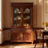 Wooden crockery cabinet with glass doors, brass handles, and intricate carved detailing