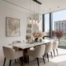 Dining room with marble table, pendant lighting, and beige upholstered chairs