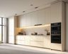 Wall-to-wall open kitchen with integrated oven, under-cabinet lighting, and handleless cabinetry