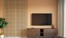 Wooden TV console with ornate patterned wall panel and warm earthy tones