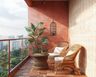 Balcony Design with Terracotta Walls and Rattan Seating