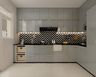 Grey L-Shaped Modern Kitchen Design with Chevron Tile Backsplash and Glass Display Niches