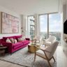 Living Room Design with Pink Velvet Sofa, Gold Coffee Table and Off-White Occasional Chairs