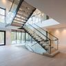 L-Shaped Staircase Design with Glass Railings and Wooden Steps