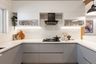 1. Subway White Porcelain Kitchen Tiles In U-Shaped Kitchen - Livspace 2. White Porcelain Subway Kitchen Tiles With Breakfast Counter - Livspace