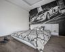 Neutral-Tone Bedroom Wallpaper With A Car Mural - Livspace