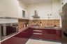 L-Shaped Kitchen Design with Dark Red Cabinets