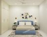 Cream And Blue Guest Room Design With 4-Door Swing Wardrobe And Blue Bed - Livspace