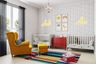 Vibrant Eclectic Kids Room for Two with White Cribs, Red Storage Unit, and Yellow Accent Chair - Livspace