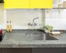 Modern Stainless Steel Kitchen Sink With Grey Countertop And Overhead Yellow Cabinet - Livspace