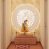 Modern pooja room in Persian Walnut, large drawer storage unit, white circular back panel, beige leafy wallpaper. - Livspace