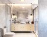 Modern bathroom design with grey tiles, vanity, glass shower partition, and mirror - Livspace