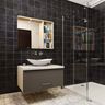 Contemporary bathroom design with black tiles, vanity, and a glass shower partition - Livspace