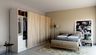 Minimal guest bedroom design with queen bed, sliding wardrobe, and beige accent wall - Livspace