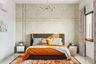 Modern guest bedroom design with queen bed, pendant light, and beige wallpaper- Livspace