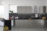 Contemporary L-shaped kitchen design with storage units, quartz countertop and profile lighting - Livspace