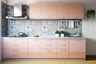 Modern open kitchen design with cabinets, drawers in rose granium color, and high-gloss finish- Livspace