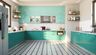Modern Indian kitchen design in aqua green color, quartz countertops, and black and white floor- Livspace