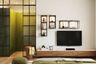 Modern TV unit design with wall-mounted drawer, and open shelves with spotlights- Livspace