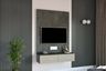 Modern TV unit design with dove grey base units, wall mounted drawer units and back panel - Livspace